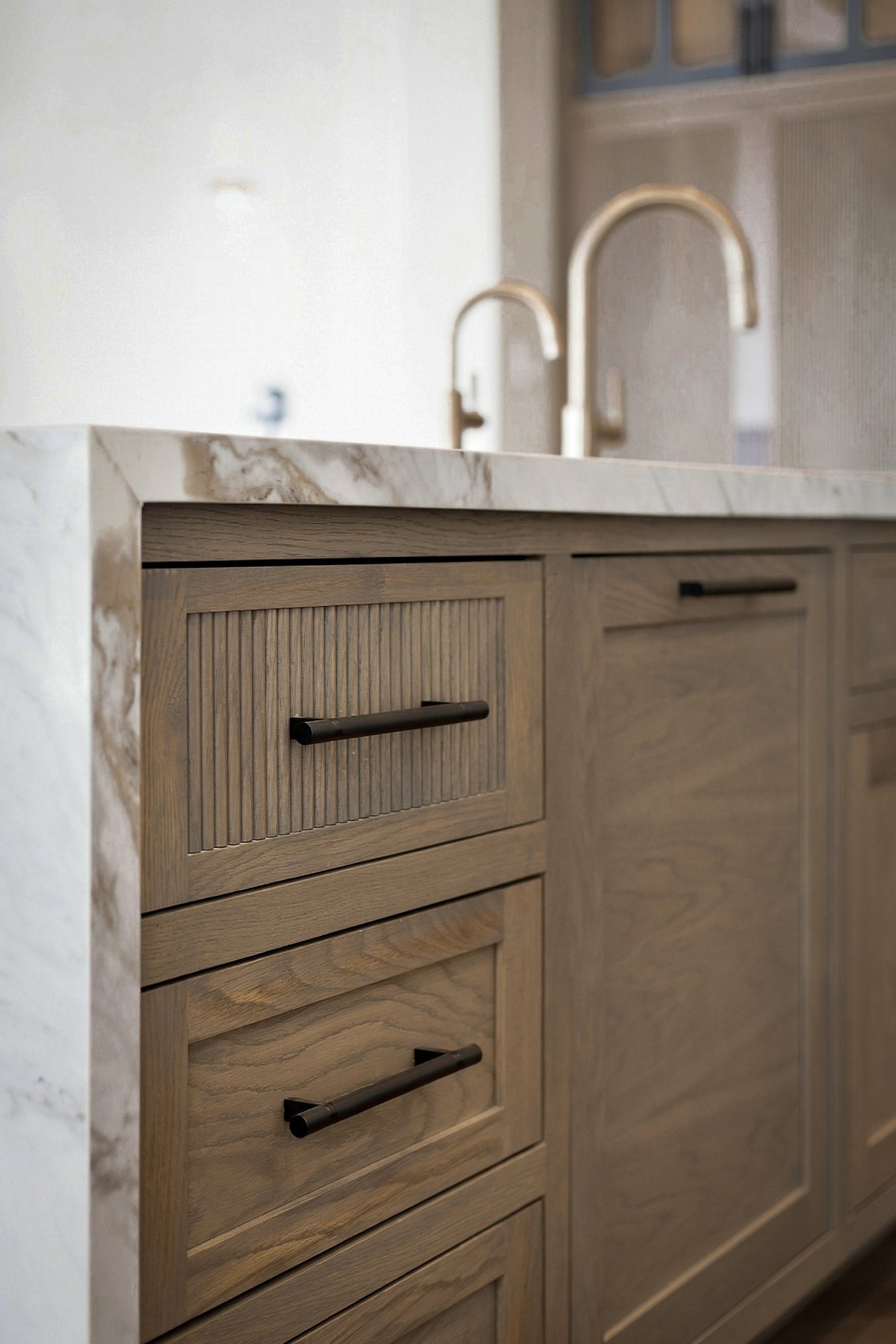 Fluted white oak vanity with brass hardware